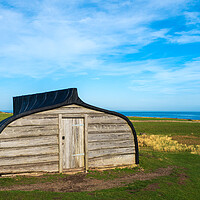 Buy canvas prints of Lindisfarne Boat Shed. by Tommy Dickson