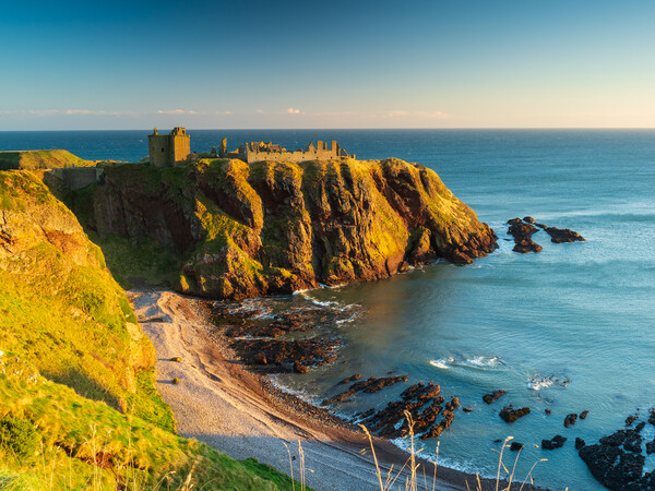 Sunrise at Dunnottar Castle, Aberdeenshire.  Picture Board by Tommy Dickson