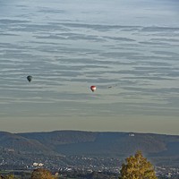Buy canvas prints of  Hot air balloons over the hills by Mark Bangert