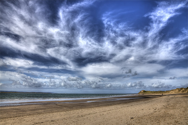 Swirling clouds and blue skies over Saunton Devon Picture Board by Mike Gorton