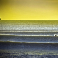 Buy canvas prints of  Solo surfing at a Gower beach by Spenser Davies