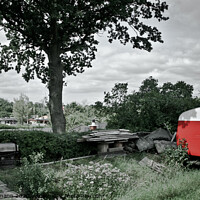 Buy canvas prints of Red trailer parked next to a big tree by Sandra Broenimann