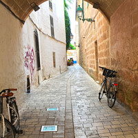 Buy canvas prints of Cobblestone Alleyway in Ciutadella Menorca by Deanne Flouton