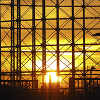 Buy canvas prints of Sunset through gas holder by Andy Huntley