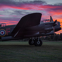Buy canvas prints of Lancaster bomber Just Jane with a sunset by Alan Tunnicliffe