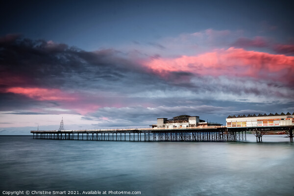 Sunset over Colwyn Bay Pier, North Wales Picture Board by Christine Smart
