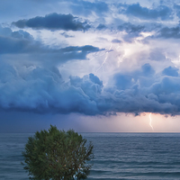 Buy canvas prints of Thunderstorm and lightning over the ocean by Nikos Vlasiadis