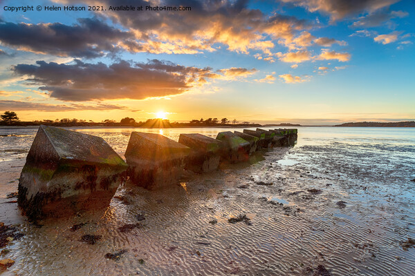 Beautiful sunset over old WWII tank traps in Bramble Bush Bay  Picture Board by Helen Hotson