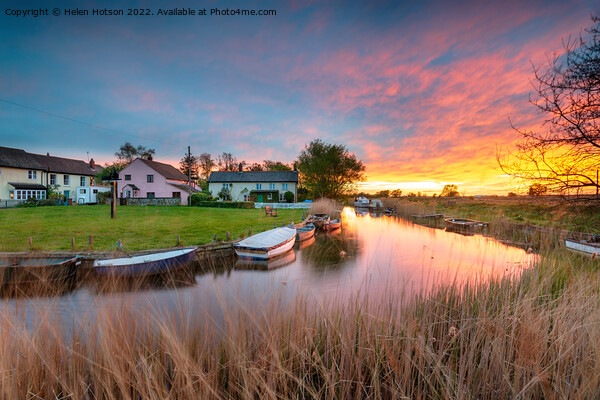 Stunning sunset over the village green and boats on the river at Picture Board by Helen Hotson