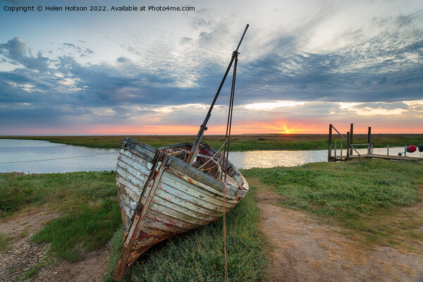 Sunrise over abandoned fishing boat on the shore at Thornham  Picture Board by Helen Hotson