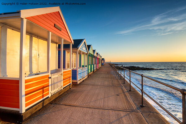 A row of pretty beach huts at Southwold  Picture Board by Helen Hotson