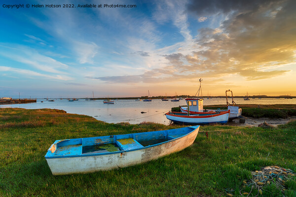 Beautiful sunset over old fishing boats in Suffolk Picture Board by Helen Hotson
