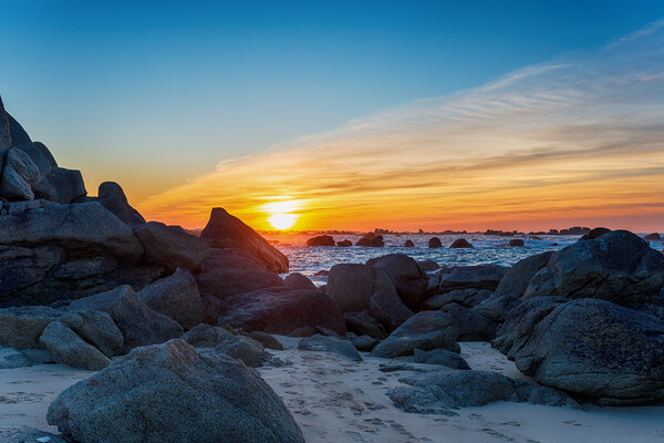 Sunset over rocks on the beach at Meneham Picture Board by Helen Hotson