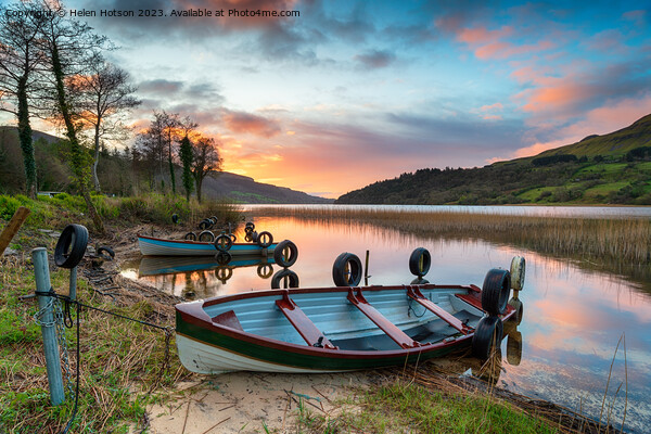 Beautiful sunrise over rowing boats at Glencar Lough Picture Board by Helen Hotson