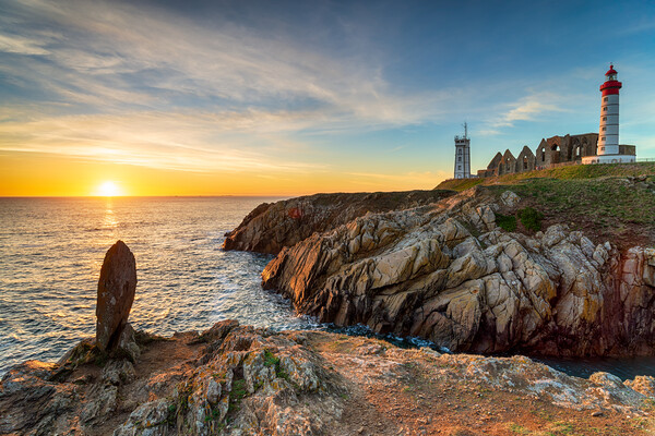 Beautiful sunset over the lighthouse at Saint Mathieu Picture Board by Helen Hotson