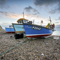 Buy canvas prints of Fishing boats on the beach at Beer in Devon by Helen Hotson