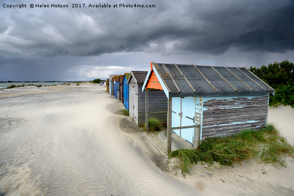 Beach Huts Under A Stormy Sky Picture Board by Helen Hotson