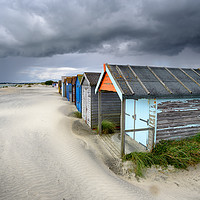 Buy canvas prints of Beach Huts Under A Stormy Sky by Helen Hotson