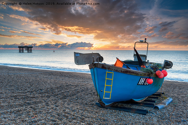 Dramatic sunrise sky over a fishing boat on the be Picture Board by Helen Hotson