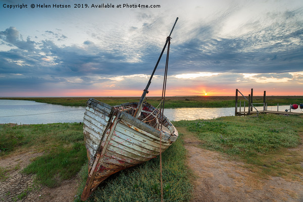 Sunrise over abandoned fishing boat on the shore a Picture Board by Helen Hotson