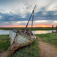 Buy canvas prints of Sunrise over abandoned fishing boat on the shore a by Helen Hotson
