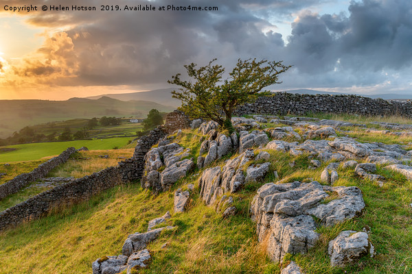Stormy sunset over a small limestone pavement Picture Board by Helen Hotson
