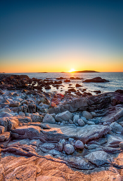 Sunset over the rocky beach at Mealista  Picture Board by Helen Hotson