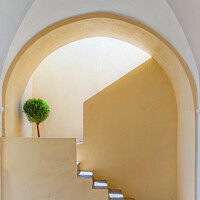 Buy canvas prints of Santorini Sunlit Arched Stairwell by Antony McAulay