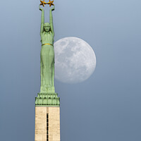 Buy canvas prints of Riga Freedom Monument at Moonrise by Antony McAulay