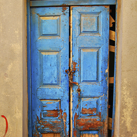 Buy canvas prints of worn down blue door by Antony McAulay