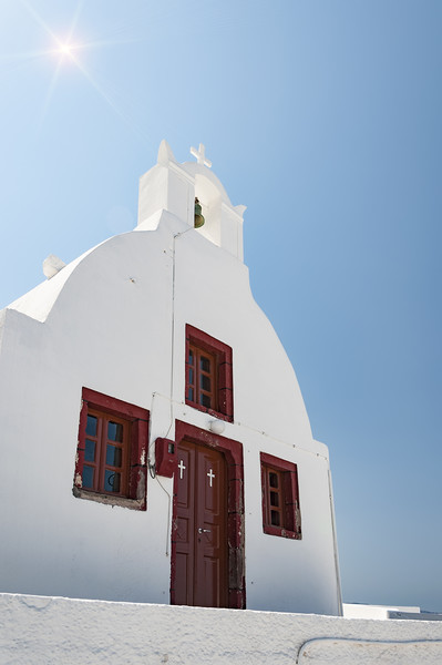 Oia Village Church with sunflare Picture Board by Antony McAulay