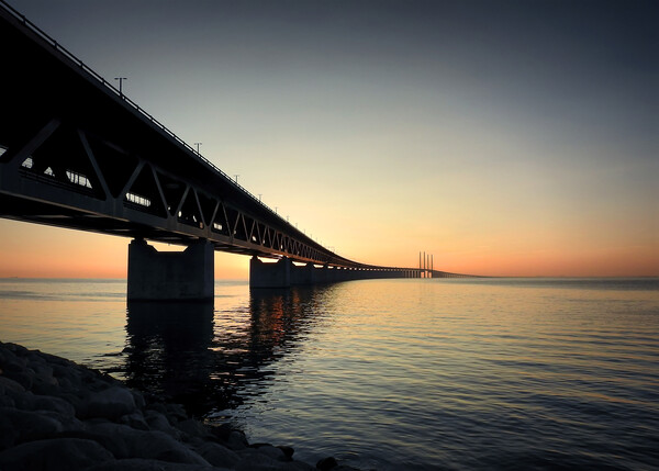 Oresunds Bridge Silhouetted at Sunset Picture Board by Antony McAulay