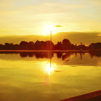 Buy canvas prints of  Sun Going Down Over Eaton Park Lake by Vincent J. Newman