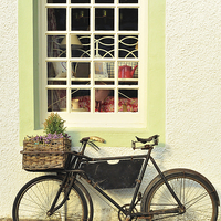 Buy canvas prints of Bike Outside Old-Fashioned Shop by Bridget McGill