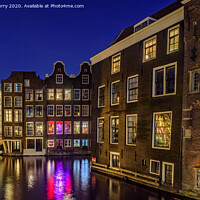 Buy canvas prints of Amsterdam Canal Houses De Wallen At Night The Netherlands by Chris Curry