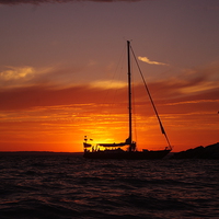 Buy canvas prints of Sunset Sailboat by Ian Pettman