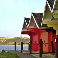 Buy canvas prints of North Bay Chalets by Andrew McCauley