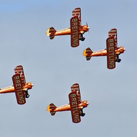 Buy canvas prints of  The Breitling Wing Walking Display Team High Over by Peter Farrington