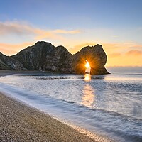 Buy canvas prints of Sunrise through the arch of Durdle Door Dorset  by Shaun Jacobs
