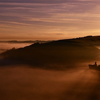 Buy canvas prints of Corfe Castle through a misty sunrise by Shaun Jacobs