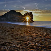 Buy canvas prints of Sunrise through Durdle Door on a winter morning  by Shaun Jacobs