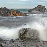 Buy canvas prints of Waves against the rocks by Derek Dobbie