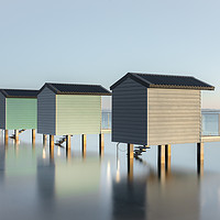 Buy canvas prints of Pastel Beach Huts at high tide by Kelvin Trundle