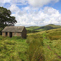 Buy canvas prints of An old Barn with Shutlingsloe Hill in the distance by John Keates