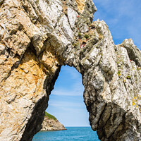 Buy canvas prints of Natural Rock Arch on Anglesey Coast by Pearl Bucknall