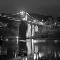 Buy canvas prints of Illuminated Menai Bridge: Reflections at Night by Pearl Bucknall