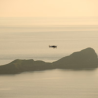 Buy canvas prints of Small plane over Worm's Head, Rhossili, Gower, UK by Bernd Tschakert