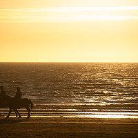 Buy canvas prints of Beach Sunset, Two Horse Rider Silhouettes, England by Bernd Tschakert