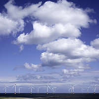 Buy canvas prints of   Offshore wind farm under a blue sky and white  c by Peter Jordan