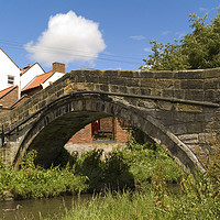 Buy canvas prints of An old pack horse bridge joining the High Street t by Peter Jordan